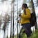 Guest wearing hiking gear in a forest walking through nature